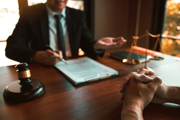 criminal defense attorney and client at desk